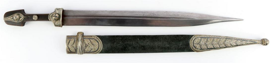 CAUCASIAN KINJAL DAMASCUS AND NIELLO DAGGER: Steel Damascus style blade that is not etched. Carved horn handle with niello fittings. Housed in leather scabbard with similar niello fittings. Measures 19 5/8 inches. Very good condition. Some loose