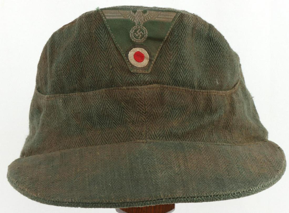 WWII GERMAN HERRINGBONE TWILL FIELD CAP: HBT pattern with cockade on the front of visor. Slight fluorescing on patch. Ink stamped on interior. Fits a small head. Very good condition with age.