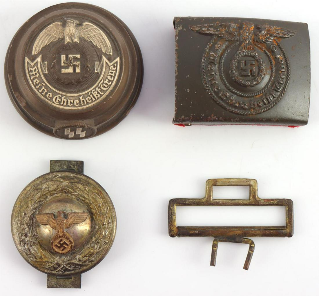 WWII GERMAN REICH WAFFEN SS BELT BUCKLES: Enlisted man's belt buckle marked "RODO" on reverse with adhesive remains on back. What appears to be a political belt buckle is present as well, marked "SS" and "RZM" on reverse. Includes an SS paper