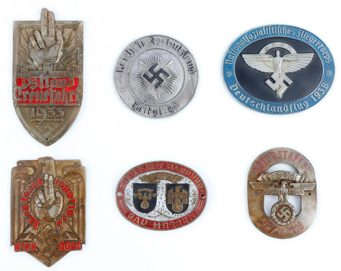 6 WWII GERMAN REICH NSKK & OSTLAND SHIELD BADGES: Lot of six (6) WWII German Reich shield badges including a 1933 Ostland shield, a 1934 NSKK/DDAC shield, a 1938 NSFK pilot's championship badge, a 1934 NSKK/DDAC Marburg rally shield, a NSKK motorstaf