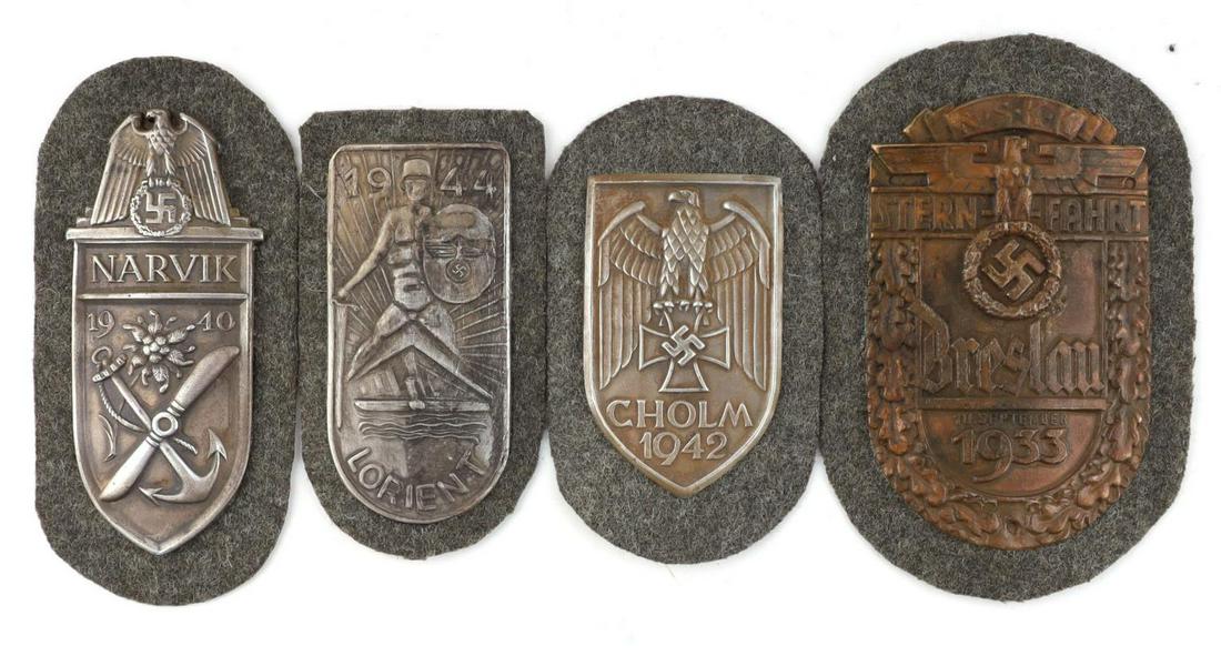 4 GERMAN WWII MILITARY NARVIK CHOLM SHIELD BADGES: Lot of four (4) German WWII Military Shield badges including a Cholm 1942 shield, Lorient 1944 shield, a Narvik 1940 shield and a Breslau 1933 shield badge. Badge size approx. 4 1/4 inches. Good condi