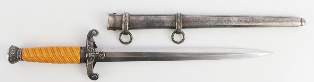 WWII GERMAN REICH HEER DAGGER W SCABBARD: Steel blade Waffenfabrik Weyersburg marked. Orange bakelite grip with silvered nickel crossguard and pommel. Housed in silvered pebble scabbard. Toning featured where scabbard meets crossguard. Measur