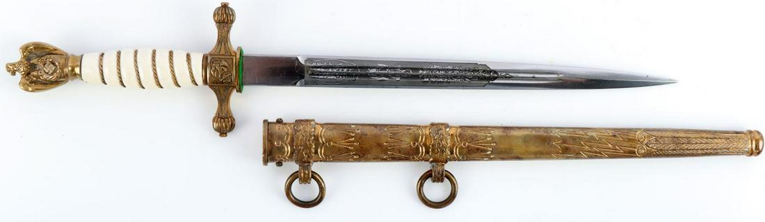 WWII GERMAN ENGRAVED KRIEGSMARINE OFFICER DAGGER: WWII German Kriegsmarine officer dagger with scabbard. White colored celluloid grip with twisted brass wire. Reichsadler to pommel with some wear. Crossguard features an anchor and rope to center with