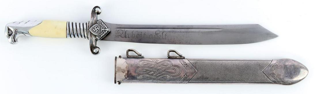 WWII GERMAN THIRD REICH RAD DAGGER: WWII German RAD Hewer dagger with scabbard. Etched motto. Alcoso maker. Aluminum handle with celluloid grip plates. Housed in silvered scabbard. Measures 15 5/8 inches. Very good condition.