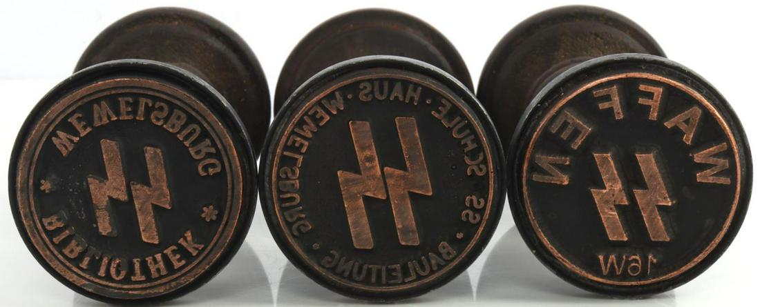 3 WWII GERMAN REICH WAFFEN SS WOODEN HAND STAMPS: Lot of three (3) WWII German Reich wooden hand stamps including a Waffen SS stamp and two hand stamps from the SS leadership school in Wewelsburg. Hand stamp sizes approx. 4 1/2 inches. Unauthenticate