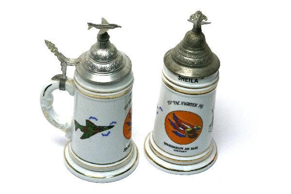 TWO UNIT STEINS 23RD TAC FIGHTER SQUADRON: Lot of two unit commemorative steins both 23rd Tac. Fighter Squadron, 52nd Tactical Fighter Wing, Spangdahelm Air Base, Germany, presented to "M. E." and "Sheila". Both with lithophane in bottom, and 