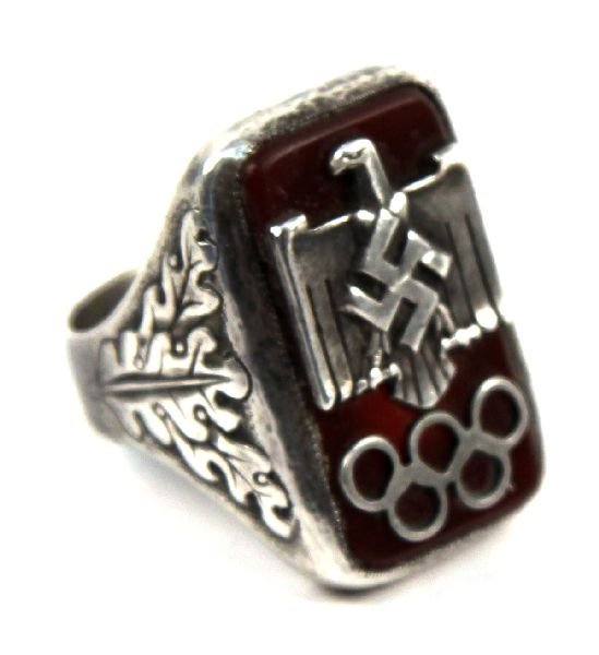 RARE 1936 BERLIN OLYMPIC RING GIVEN TO CARL DIEM: Nazi sports eagle stands above the Olympic rings on the face of this silver ring. Oak leaves on side panels. Named inside to Carl Diem the Sec. Gen. of the 1936 games in Berlin. There were limited num
