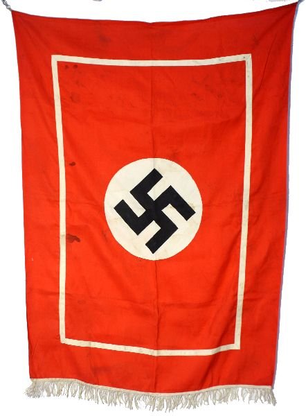 WWII GERMAN SWASTIKA FRINGED PODIUM FLAG BANNER: WWII podium banner with fringes at bottom. Overall in good condition with small hole and some minor staining. Measures 42 by 29 inches.