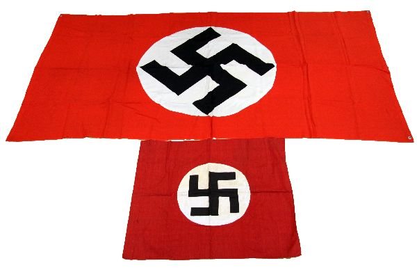 2 GERMAN THIRD REICH FLAGS WITH VEHICULAR FLAG: Two German Third Reich flags. The larger of the two, a Nazi Vehicular flag, measures 74 by 37 inches. The smaller, a Nazi party flag, measures 21 by 25.5 inches. The vehicular flag has some small tear