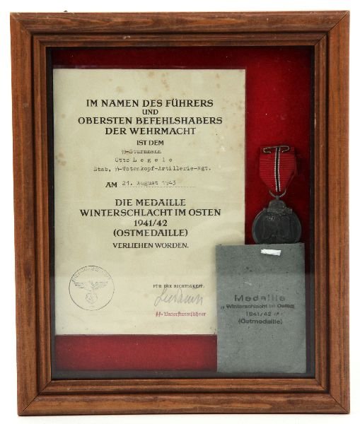 WWII GERMAN SS WINTER SERVICE MEDAL & CITATION: WWII Winter service medal with original envelope and named citation, SS Sturman Otto Legele, framed.