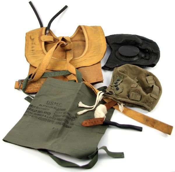 WWII FLYING HELMET B-4 FLOTATION USMC BLADDER: WWII military grouping consisting of: leather USN cadet flying helmet, A-3 Army Air Corp flying helmet, 1945 dated B-4 Life preserver, and a USMC 1944 dated flotation bladder.
