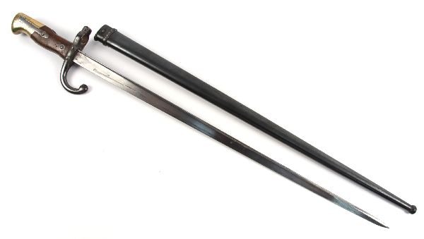 WWI FRENCH BAYONET WITH DEDICATION: WWI French bayonet with dedication on the blade of the spine. Matching serial numbers on bayonet and scabbard. Blade measures 22.5 inches long. Dated 1880. Some wear to handle, slight oxidization to b