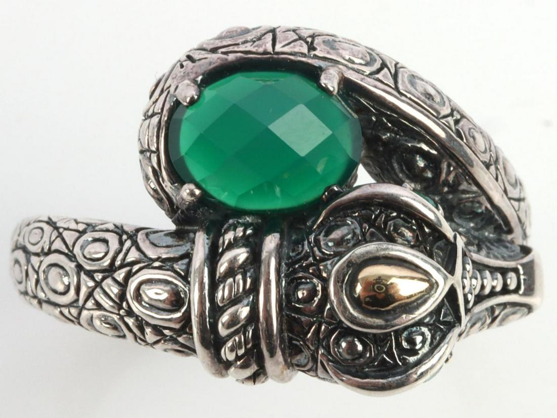 JOHN HARDY CROCODILE RING EMERALD EYES IN STERLING: Size 10.5. Sterling silver ring with 14kt gold accent on the head. Emerald eyes with faceted stone tail. Interior marked JAI 925 14KT. Weighs 11.9 grams. Weight: mt safe This lot has a reserve.