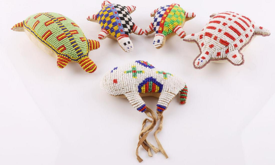 LOT OF 5 NATIVE AMERICAN TURTLE AND BISON EFFIGY: Lot contains 4 turtle effigies and one bison effigy. Variety of hand beaded details and sizes. Crafted from leather. Measurements range 4 5/8 - 6 3/4 inches.