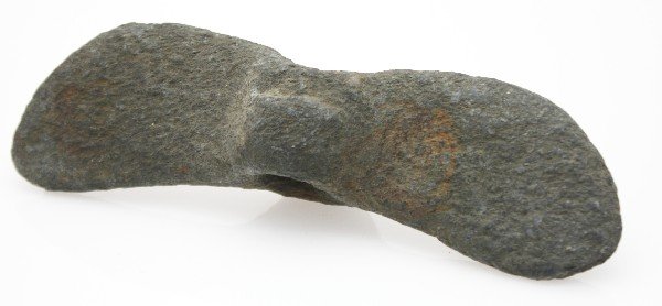 INDIAN STONE AX OR TOMAHAWK BANNERSTONE: At first glance appears to be a banner stone, but the hole is not all the way through, so one would assume a ax head or skull crusher, of stone and measuring 6 inches,
