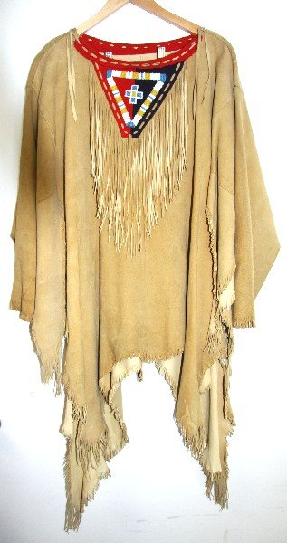 NATIVE AMERICAN BEADED WAR SHIRT: Native American beaded war shirt made of suede and wool. Geometrical bead work includes colors light blue, white, and yellow. Measures approximately 33 inches long, shoulder width 23 inches, arm lengt