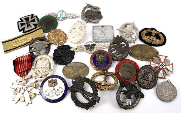 WWII GERMAN REPRO & QUESTIONABLE BADGES & MORE: Huge lot of WWII German badges and insignia. All are either certain reproduction or of dubious authenticity and origin. 24 badges and three patches in all. Ideal for display and reenactment.