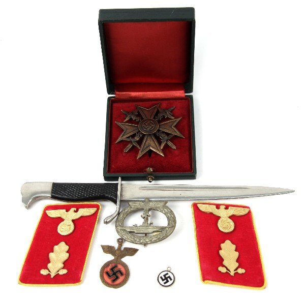 GROUPING OF WWII THIRD REICH ITEMS MOSTLY REPRO: Lot includes reproduction collar tabs, reproduction Spanish Condor Legion cross, sputious U-boat badge marked "GWL" on back, bayonet letter opener, and two small Nazi party medallions.