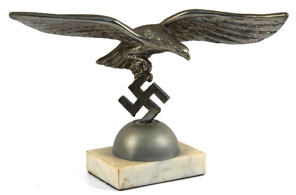 WWII GERMAN LUFTWAFFE DESK EAGLE ON MARBLE BASE: Luftwaffe Eagle on Swastika with semi circle base mounted to white marble base. Wingspan is 9.5 inches overall height is 6 inches. All non-ferrous metals. Questionable authenticity.