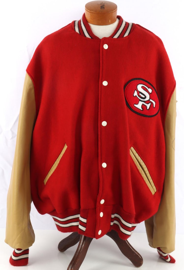 SAN FRANCISCO 49ERS JOE MONTANA SIGNED JACKET: San Francisco 49ers letter jacket autographed by Joe Montana. Red wool jacket with gold leather arms. Super Bowl Champions patch to the left arm. Logo to the left breast. Back reads 49ers Football. Si