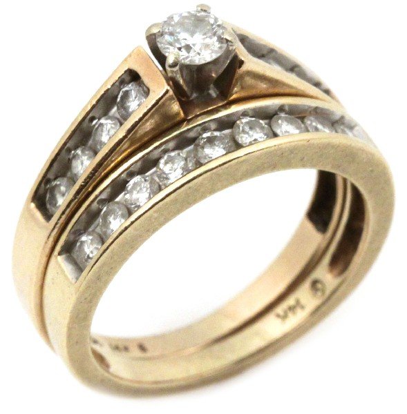 LADIES MATCHING 14K GOLD & DIAMOND WEDDING SET: Ladies 14K yellow gold and diamond wedding set. Engagement ring features large round cut diamond set in a four prong setting approx 0.25 cts. flanked by eight channel set diamonds approx. .032 cts. ea
