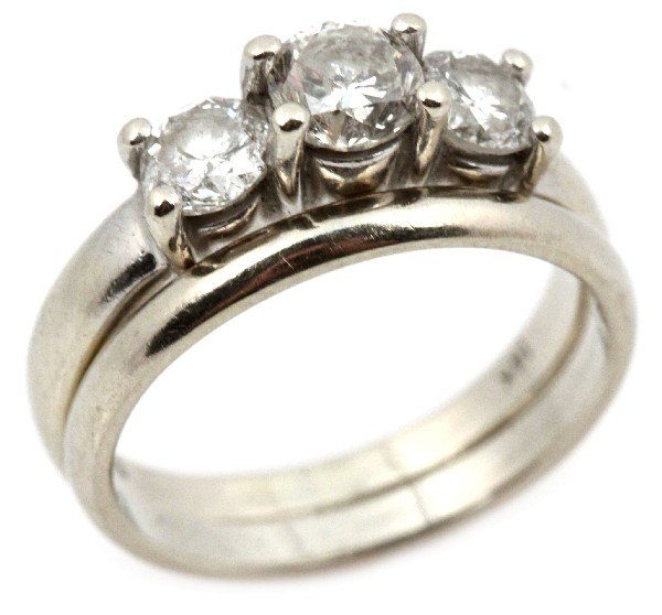 LADIES 14K WHITE GOLD & DIAMOND WEDDING SET: Ladies 14K white gold and diamond wedding set. Engagement ring features three round cut diamonds, largest center stone approx. 0.30 cts., the two smaller stones are approx.0.20 cts. each. Comes with m