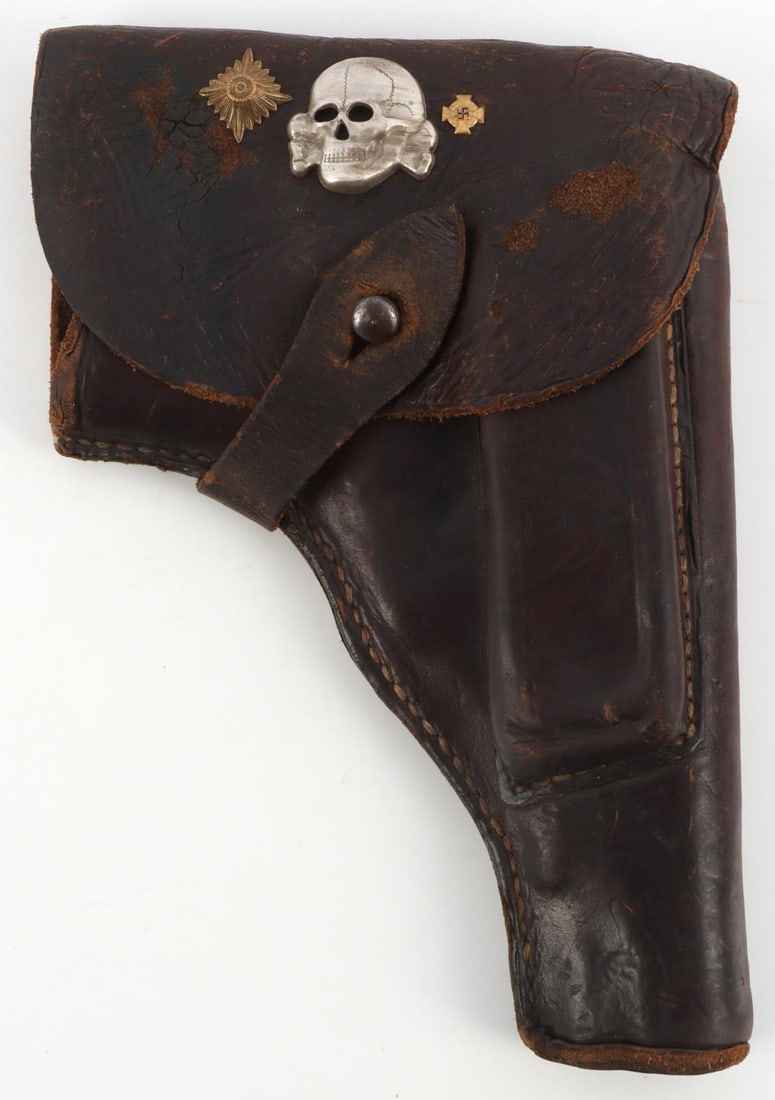 GERMAN WWII RADHOM PISTOL HOLSTER WITH SS SKULL: German WWII RADOM pistol holster with SS skull. Measures 8 1/2 X 5 7/8 inches. Has a Waffen SS officers visor cap skull mounted on the front flap, along with a pip and a medal. Multi piece machine sew