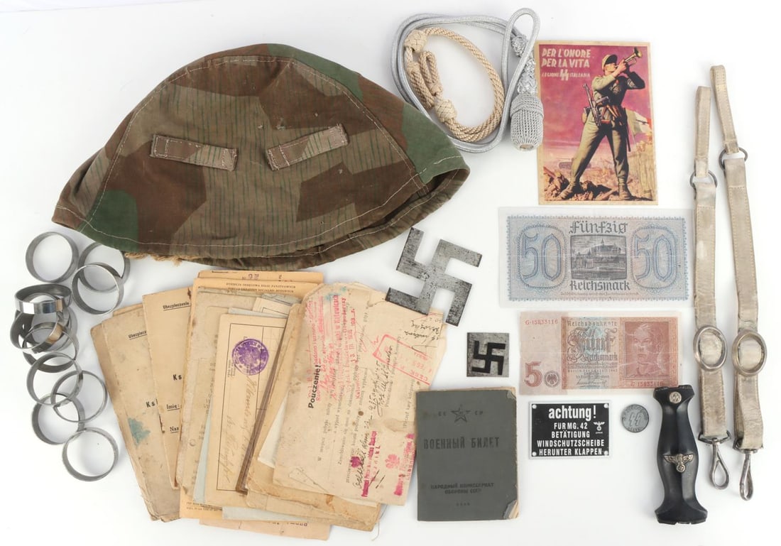 LOT OF DAGGER PARTS DOCUMENTS POSTCARD AND MORE: Lot is an assortment of WWI & WWII documents, an army camo helmet cover, an SS Italian postcard, SS coin, "void" paper money, parts for an SS dagger, visor hat, and rings for banner. Measurements rang