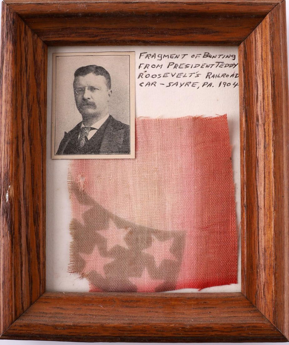 TEDDY ROOSEVELT RAILROAD CAR BUNTING SAYRE PA 1904: Bunting about 3 1/4 inches tall by 3 1/8 inches wide. Faded red color depicting upper right of a shield. In frame measuring 6 1/2 inches tall by 5 1/2 inches wide.