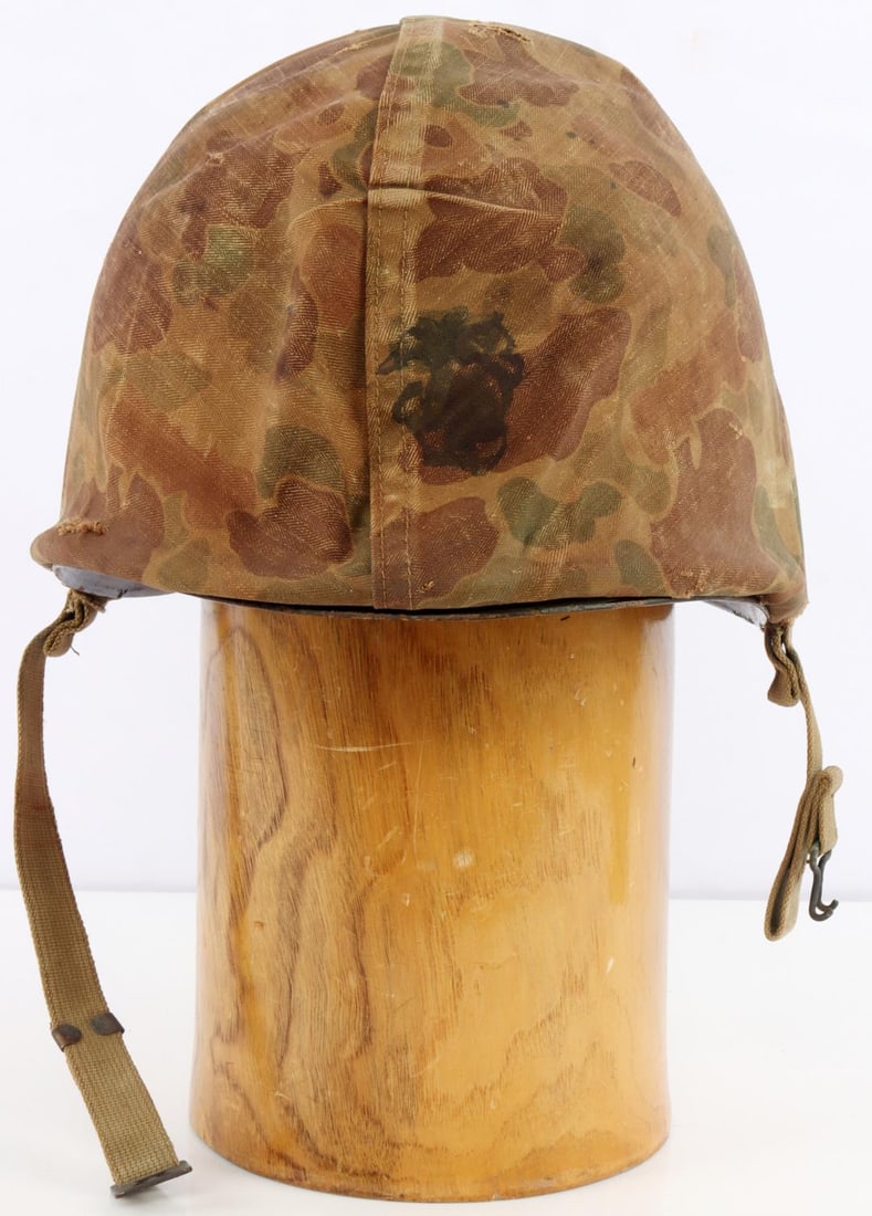 WWII US MARINE FIXED BALE M1 HELMET W CAMO COVER: Front seam M1 helmet with non-discernable heat stamp. Westinghouse Electric liner. Reversible hbt camo liner. Sewn cloth chinstraps come through the cover. Number 3 marked on top of liner. Very good c