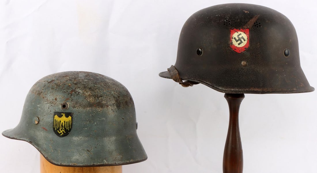 2 WWII GERMAN STAHLHELM M40 AND M42 HELMETS: M40 helmet features blue paint with painted Kriegsmarine insignia. Interior of helmet is stamped NS62. It is missing the leather liner but holds the metal liner size 54. Other helmet is a black M42 wi