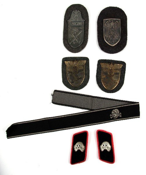 WWII GERMAN SS COLLAR CUFF & KRIM SLEEVE BADGE: Grouping of Third Reich badges and insignia, SS Panzer division collar insignia, SS death head cuff title, two Krim sleeve badges, Narvik and Cholm sleeve badges. These items are believed to be spurio