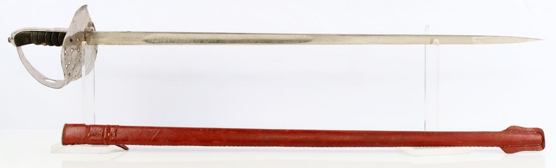 GEORGE VI BRITISH INFANTRY OFICERS SWORD SCABBARD: Reproduction of a British 1897 Infantry officer's sword with decorative blade and leather bound scabbard. Very good condition. The guard is three-quarter basket hilt is pierced and etched with a scrol