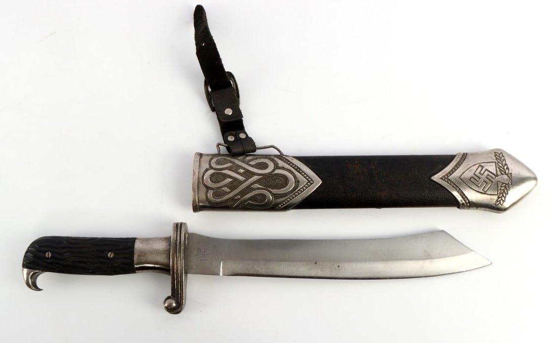 WWII GERMAN RAD DAGGER WITH SCABBARD: WWII German RAD (Reichsarbeitsdienst) dagger with scabbard. Black celluloid grips to a nickel handle. Etched blade reading "Arbeit adelt." Dull blade. Maker marked Ges Gesch Boker Solingen. Black leat
