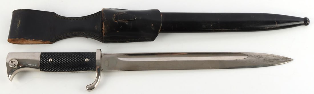WWII GERMAN THIRD REICH K98 DRESS BAYONET W FROG: Nickel plated steel bayonet with Bakelite grips and housed in anodized scabbard. Measures 15 5/8 inches. Very good condition.