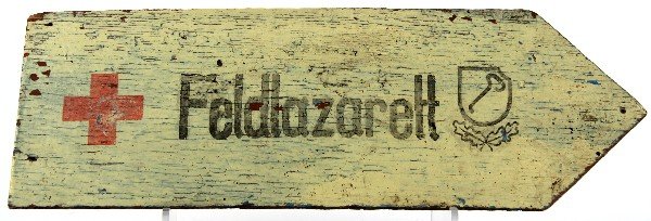 1ST SS PANZER DIVISION ROAD SIGN WITH MUSEUM TAG: First SS Panzer Division road sign with red cross and "Feldlazarett" (field hospital). Museum inventory tag on back in Cyrillic translates roughly to “Fascist street sign. Kharkov Historical Museum.