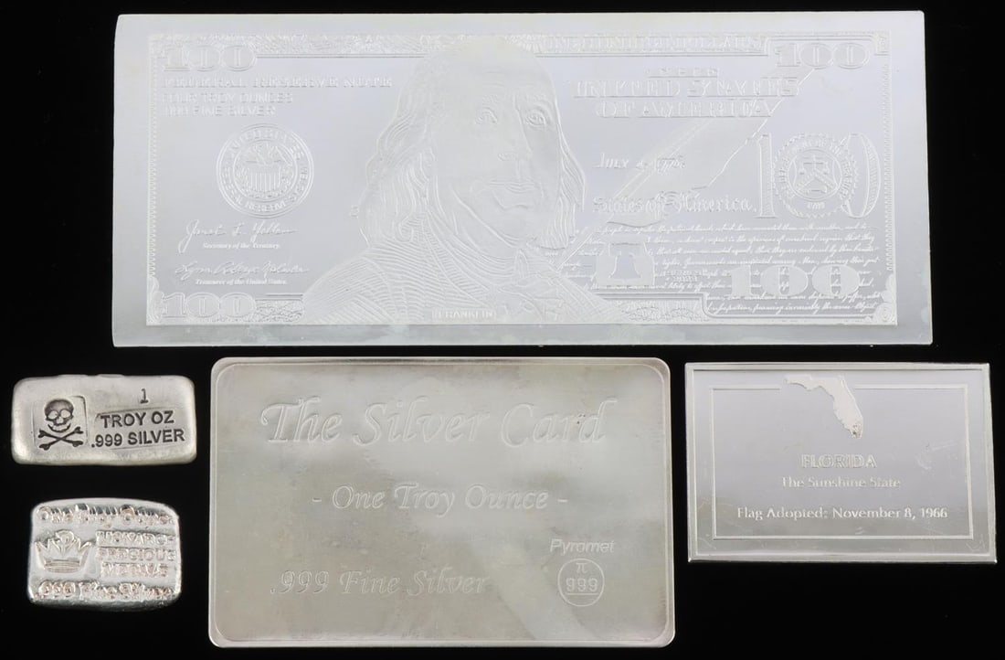 9 TROY OUNCE MIXED SILVER BULLION LOT: Lot features a 4 ounce $100 commemorative, 2 ounce Florida bar, a one ounce silver card, and two 1 ounce bars. This lot has a reserve.