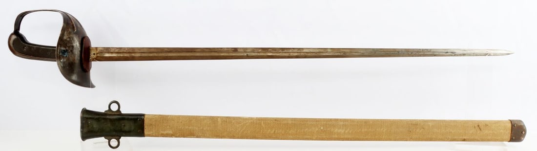 WWI U.S MODEL 1913 PATTON SWORD CAVALRY SABER: Very good blade, "1914 SA" with ordnance marking on ricasso, serial number "8469" marked on other side. Grip, guard and pommel in good condition. Canvas scabbard very good, with no rips or tears prese