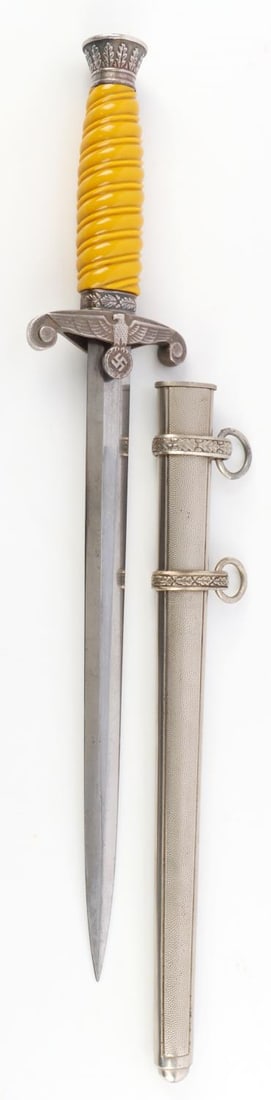 WWII GERMAN HEER MODEL 1935 OFFICER DRESS DAGGER: A WWII German Reich Heer(Army) Model 1935 Officer's Dress Dagger and scabbard. Ricasso is marked, "Original Eickhorn Solingen". Filing is present on the tang. Scabbard features swirl design. Blade is