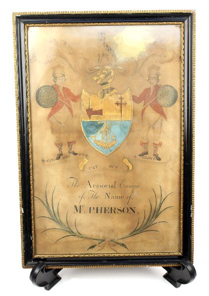 ANTIQUE FRAMED MCPHERSON CREST ARMORIAL ENSIGN: Framed Mc.Pherson crest on paper. Reads, "Touch not the cat but a glove The Armorial Ensign of the Name of Mc.Pherson." Old tag on reverse of piece reads, "John H. Paris, Liverpool." Frame measures 18