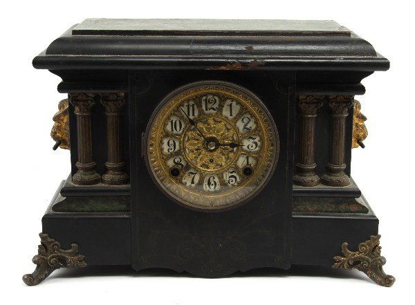 SETH THOMAS CLOCK CO. MANTLE CLOCK: Wood mantle clock with black and marbled green veneers, and four columns. No key. Appears to be in working condition; overall in good condition with chips and wear to the finish and veneer.