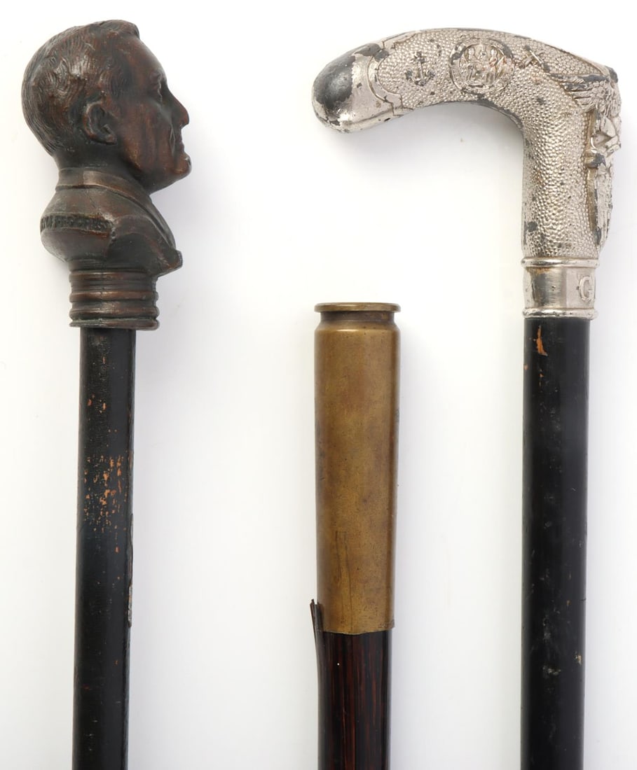 WALKING STICK LOT ROOSEVELT PROGRESS AND GAR: Lot features an FDR Century of Progress walking stick and a Civil War GAR walking stick. Both ebonized. Slight bow in GAR stick. Very good condition. Measure 36 inches. Very good condition. Also inclu