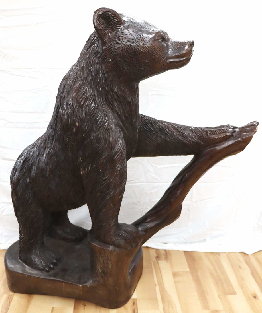 LIFE SIZE 19TH CENTURY BLACK FOREST BEAR CUB: Antique Black Forest bear cub hand carved sculpture. Approx. dimensions: 48 (H) X 18 (W) X 41 (L) inches. In good overall condition with non-detracting repairs or age related fissures to the arm, bran
