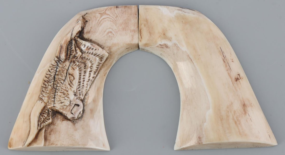 FOSSIL IVORY SINGLE ACTION COLT PISTOL GRIPS: Mammoth ivory, bull scrimshaw, 3 1/4 straight measure, along the curve 4 3/4 inches. No international sales, and know your states laws prior to bidding.