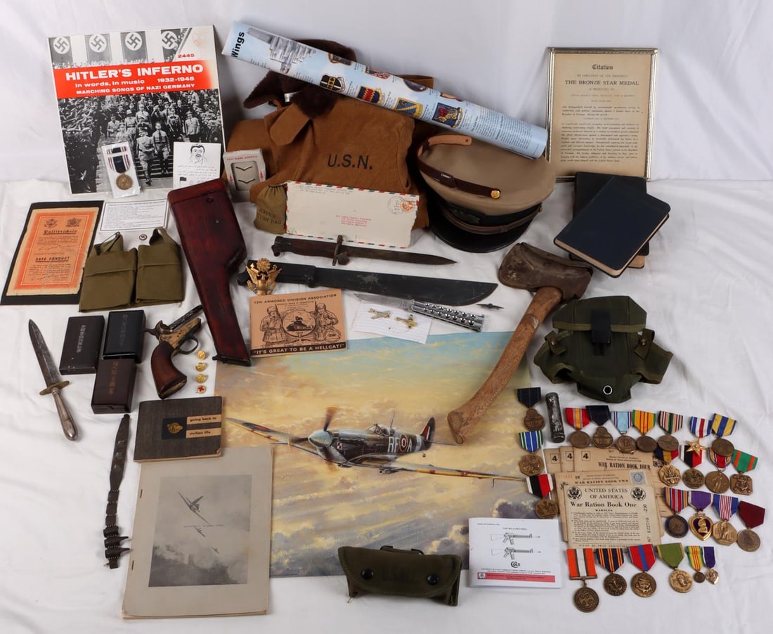 WWI WWII VIETNAM MILITARY COLLECTIBLES LOT: Far from a junk lot or sweep the kitchen group, some great items partial list includes Bronze star citation, broomhandle holster, lots of U.S. Medals, Medium USN deck jacket, Axe ,Machete, fighting kn