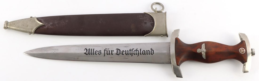 WWII GERMAN THIRD REICH SA DAGGER MALSCH AMBROWN: Standard etched SA motto with nickel crossguards, wooden handle, inlaid eagle and SA insignia. Housed in anodized scabbard. It measures 14 3/4 inches. Blade is tight in scabbard.