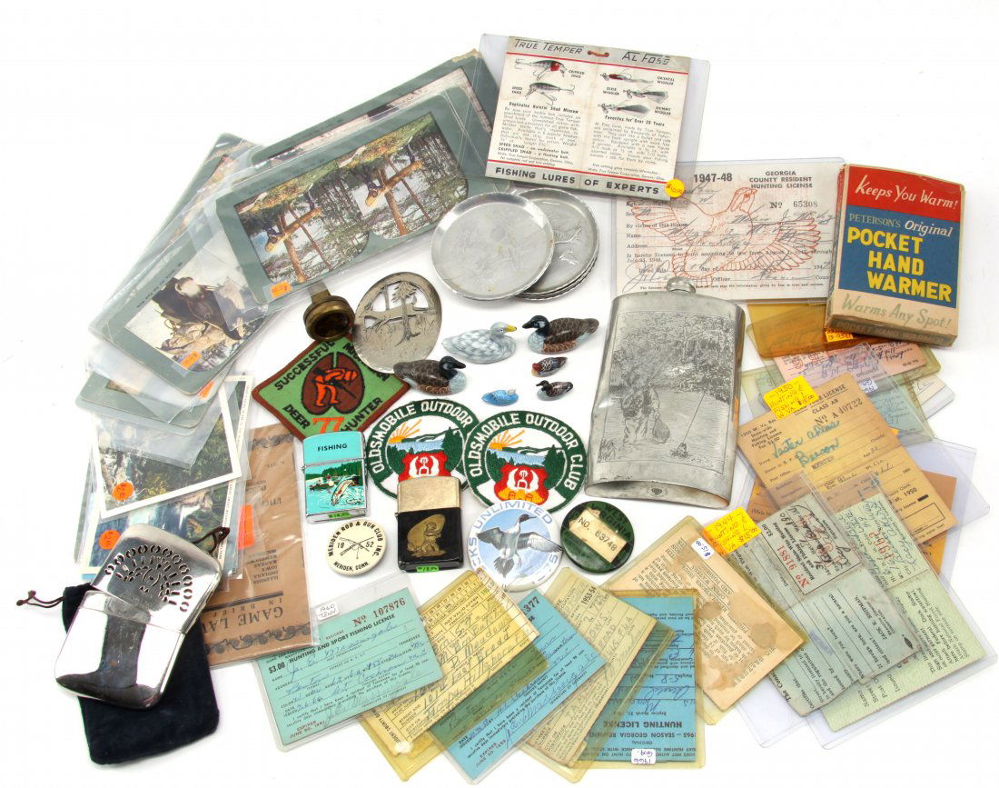 LOT OF MIXED VINTAGE SPORTING COLLECTIBLES: Lot of vintage mixed hunting and fishing collectibles. Items include 1940's hand warmer, numerous 50'S & 60'S hunting licenses, 1917 game laws handbook, two lighters, coasters, pinback buttons, patche