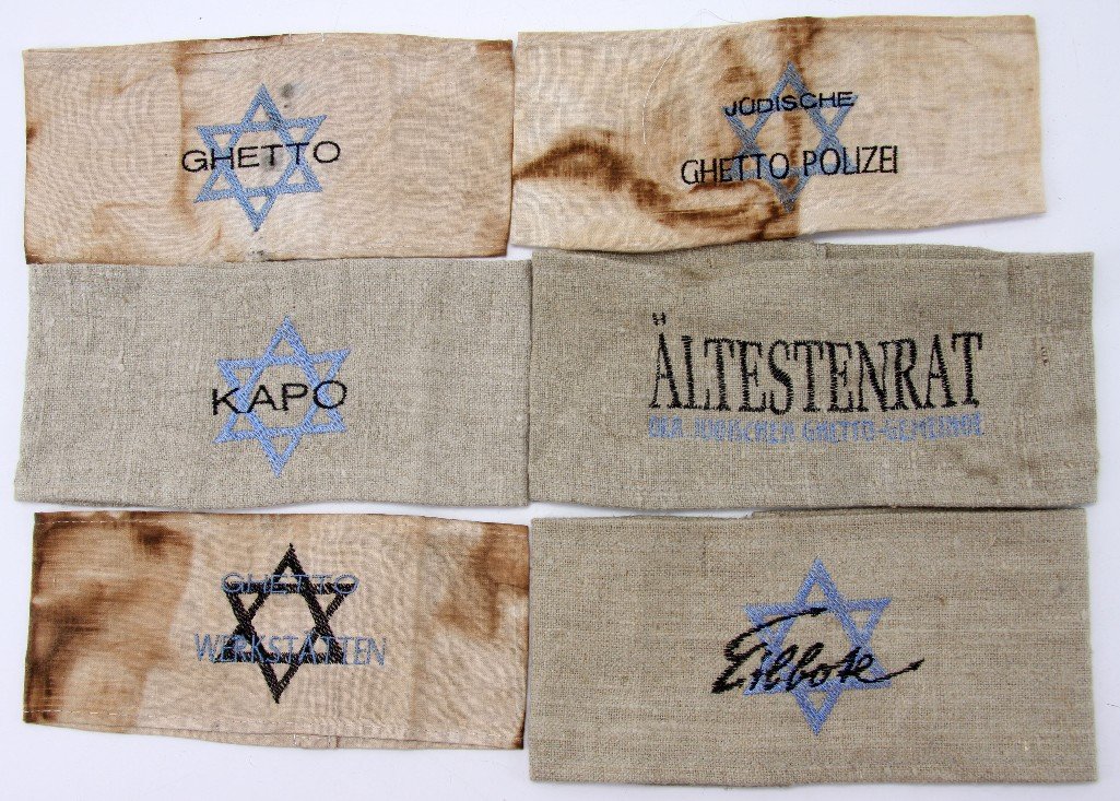SIX SPURIOUS GHETTO ARMBANDS KAPO EILBOTE JUDE: Six Ghetto Armbands, three spurious burlap embroidered with "Eilbote," "Ältestenrat der Jüdischen ghetto Gemeinde," and "Kapo." Overall condition is excellent. The other three are cloth and show wea