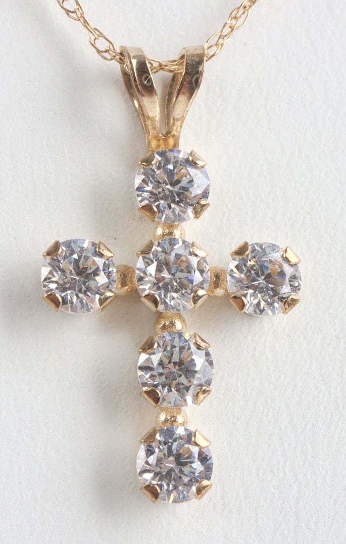 10KT YELLOW GOLD ROPE CHAIN AND CROSS PENDANT: Chain measures 18 inches long .79mm wide. Weighs .3 grams. Cross pendant also in 10kt gold with Swarovski Zirconia. It measures 17mm. Both marked 10kt and acid tests appropriately. This lot has a rese