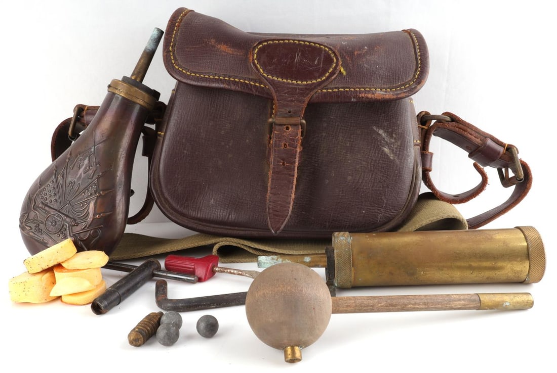 BLACK POWDER MUZZLELOADING POSSIBLES BAG: Two empty gunpowder flasks, bullet starter ball. accessories, musket balls and more. In nice leather bag.
